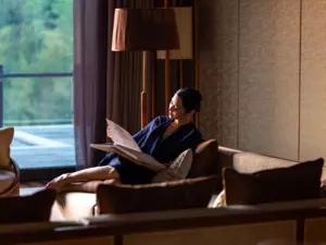 A woman reads a book in the living room